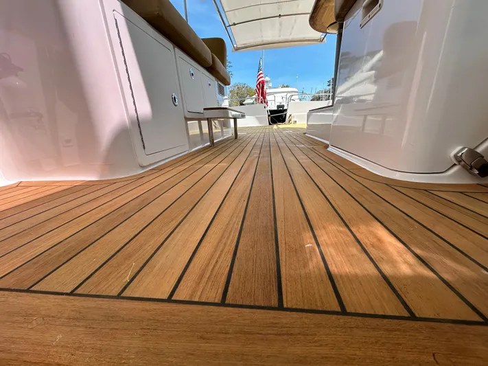  Yacht Photos Pics 2014 Back Cove Downeast 37 boat deck with teak flooring and American flag.