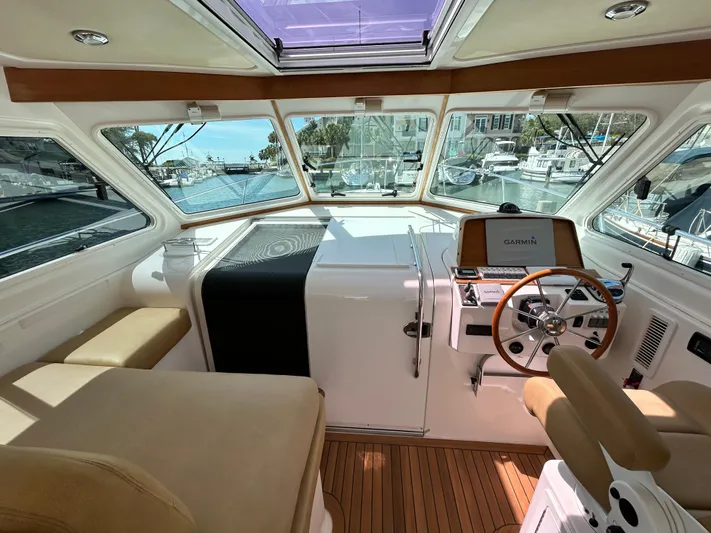  Yacht Photos Pics 2014 Back Cove Downeast 37 helm with wood accents and marina view.