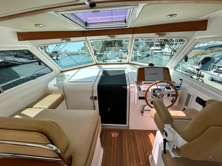  Yacht Photos Pics 2014 Back Cove Downeast 37 boat interior with helm, seating, and wood flooring.