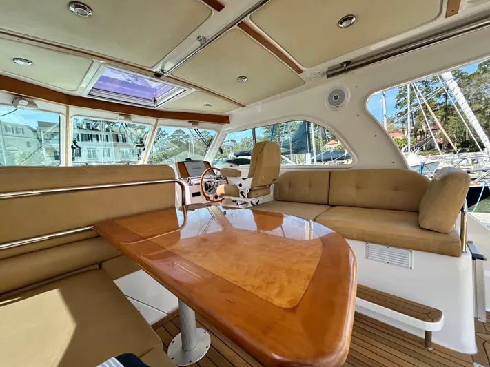  Yacht Photos Pics Interior of 2014 Back Cove Downeast 37 yacht with elegant seating and wooden table.