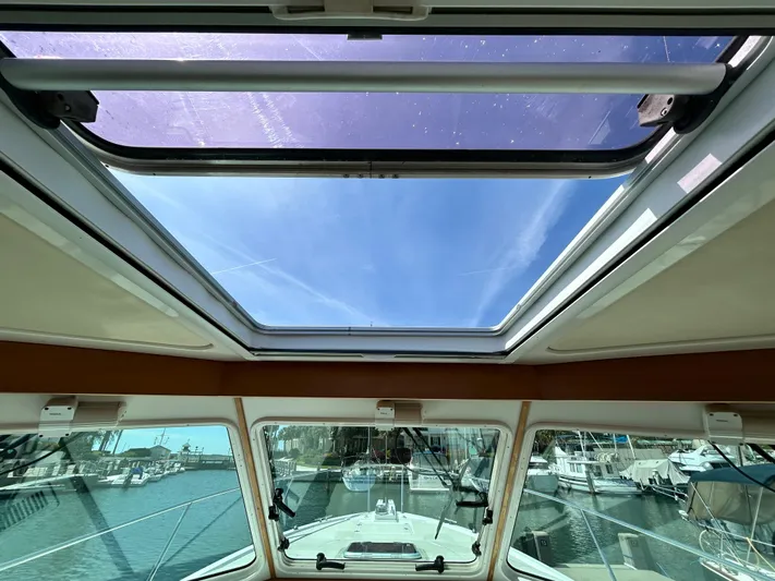  Yacht Photos Pics 2014 Back Cove Downeast 37 boat interior with open sunroof and marina view.