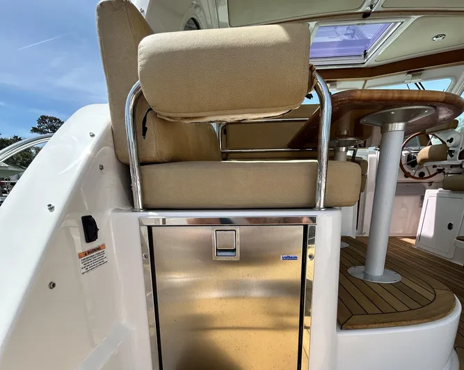  Yacht Photos Pics 2014 Back Cove Downeast 37 helm seat with stainless steel accents and wooden flooring.
