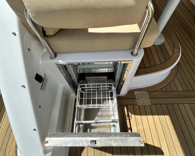 Yacht Photos Pics 2014 Back Cove Downeast 37 boat interior with open storage compartment and cushioned seating.
