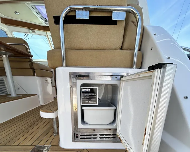  Yacht Photos Pics 2014 Back Cove Downeast 37 boat interior with open ice maker and seating.