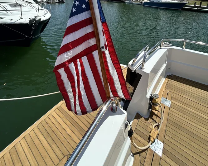  Yacht Photos Pics 2014 Back Cove Downeast 37 boat with American flag on teak deck at marina.