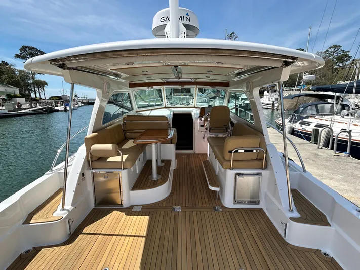  Yacht Photos Pics 2014 Back Cove Downeast 37 boat with spacious deck and seating, docked at marina.