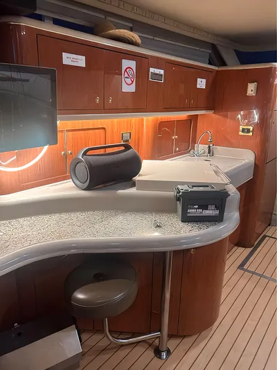  Yacht Photos Pics Interior of 2000 Sea Ray 450 Express Bridge with modern kitchen amenities and wooden cabinetry.