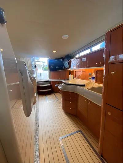  Yacht Photos Pics 2000 Sea Ray 450 Express Bridge interior with modern kitchen and wood cabinetry.