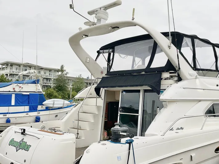  Yacht Photos Pics 2000 Sea Ray 450 Express Bridge yacht docked at marina, featuring sleek design and upper deck.