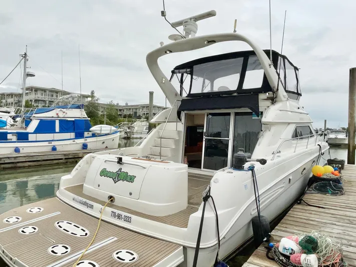  Yacht Photos Pics 2000 Sea Ray 450 Express Bridge yacht docked at marina, rear view.