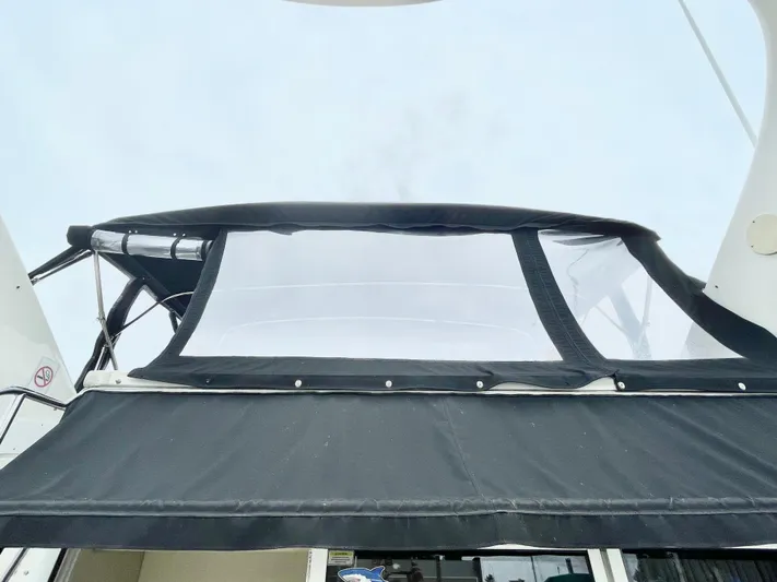  Yacht Photos Pics 2000 Sea Ray 450 Express Bridge with black canvas cover and clear windows.