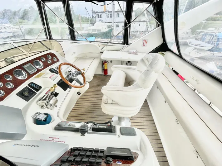  Yacht Photos Pics Interior of 2000 Sea Ray 450 Express Bridge yacht with helm and seating area.