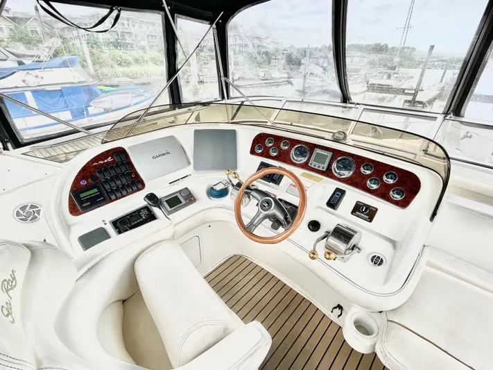  Yacht Photos Pics Cockpit of 2000 Sea Ray 450 Express Bridge with steering wheel and control panel.