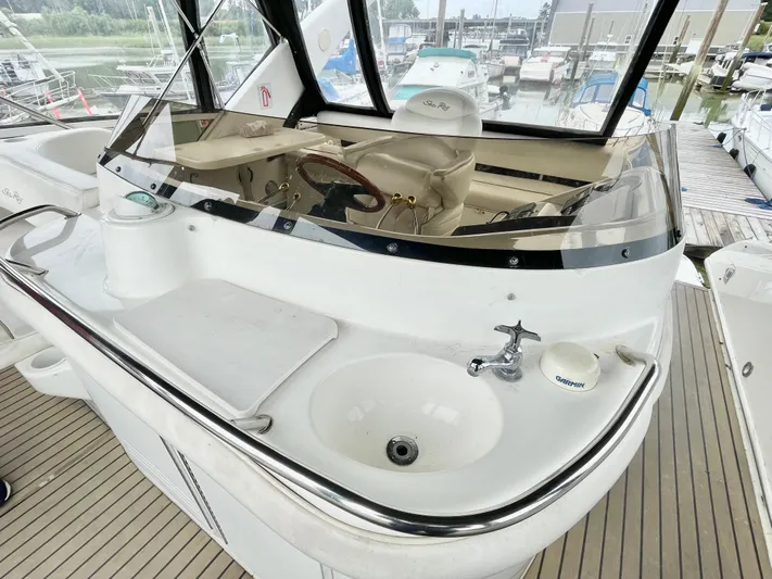  Yacht Photos Pics 2000 Sea Ray 450 Express Bridge helm with sink and cutting board on deck.