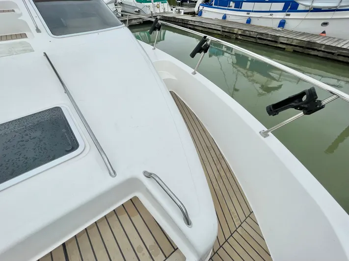  Yacht Photos Pics 2000 Sea Ray 450 Express Bridge yacht deck with wooden flooring and sleek design.