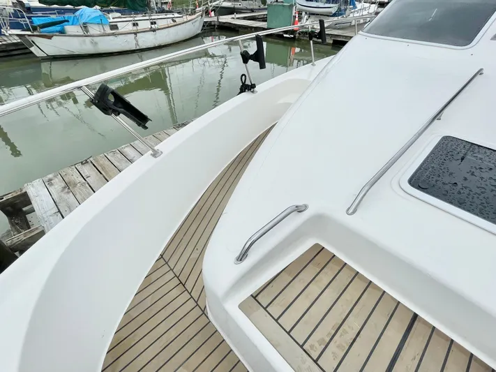  Yacht Photos Pics 2000 Sea Ray 450 Express Bridge yacht with sleek deck design at marina.