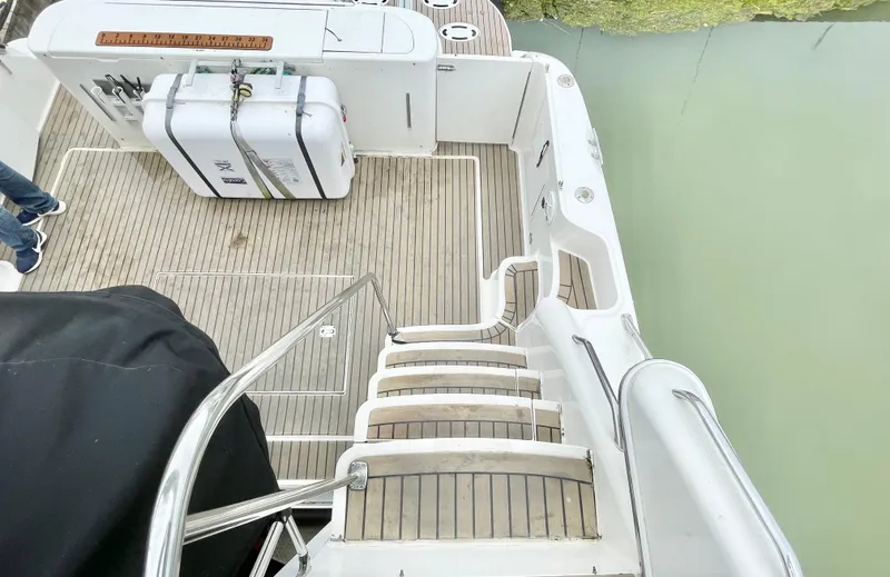  Yacht Photos Pics 2000 Sea Ray 450 Express Bridge yacht deck with wooden steps and safety equipment.