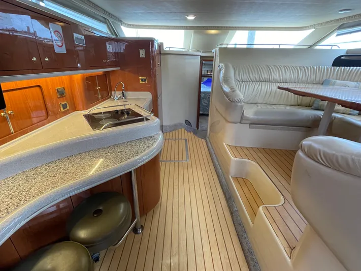  Yacht Photos Pics Interior of 2000 Sea Ray 450 Express Bridge with kitchen and seating area.