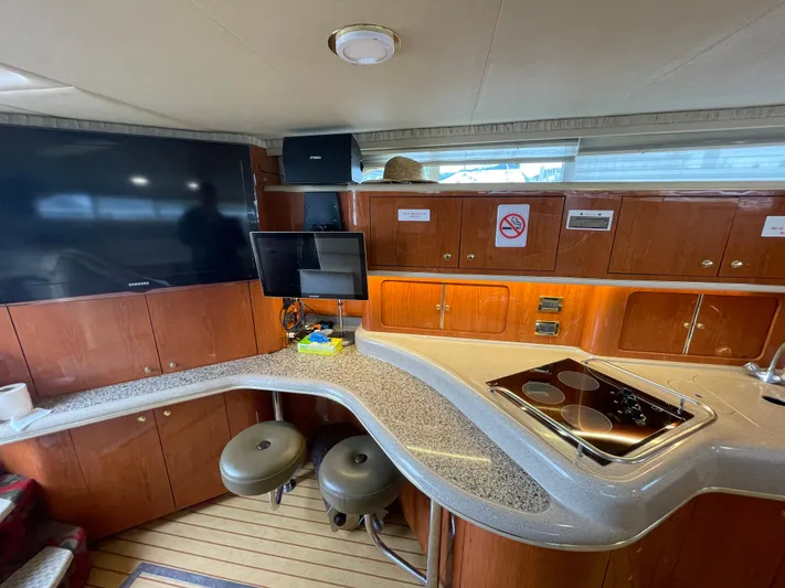  Yacht Photos Pics Interior of 2000 Sea Ray 450 Express Bridge with modern kitchen and seating area.