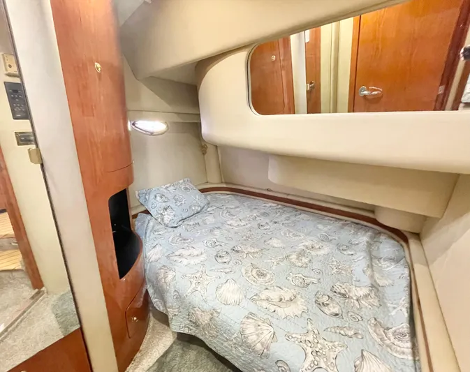  Yacht Photos Pics Cozy cabin interior of 2000 Sea Ray 450 Express Bridge with nautical-themed bedding.