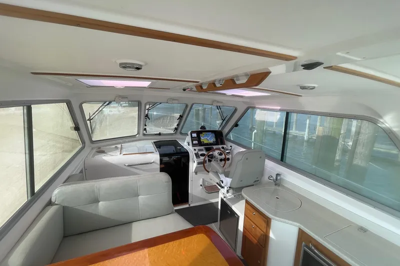 Merroir Yacht Photos Pics 2014 Back Cove 34 boat interior with helm, seating, and kitchenette.