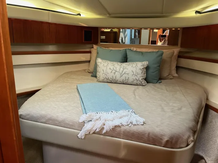 Ancora Yacht Photos Pics Luxurious bedroom interior of 1997 Tiara Yachts 40' Tiara Express with elegant bedding.