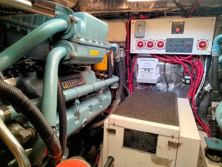 Ancora Yacht Photos Pics Engine room of 1997 Tiara Yachts 40' Tiara Express with Caterpillar engine and control panel.