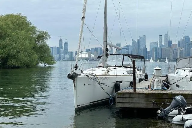 Secret Location Yacht Photos Pics Beneteau Oceanis 45 sailboat docked with city skyline in the background, 2014 model.