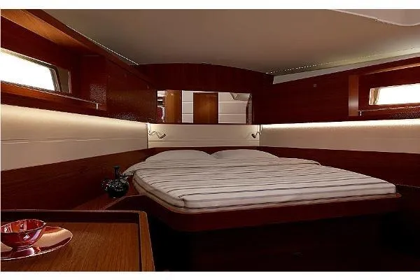 Secret Location Yacht Photos Pics Luxurious cabin interior of 2014 Beneteau Oceanis 45 yacht with cozy bed and wooden finish.