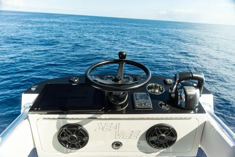  Yacht Photos Pics 2019 SeaVee 390Z boat helm with ocean view, featuring steering wheel and controls.