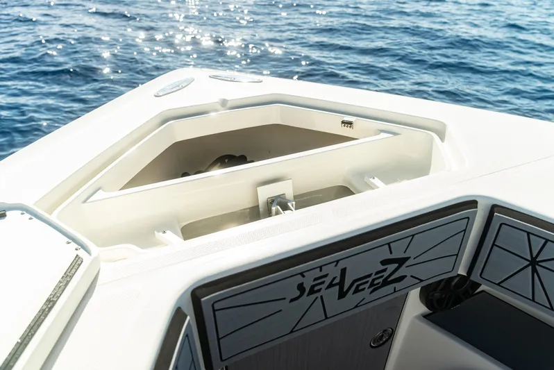  Yacht Photos Pics 2019 SeaVee 390Z boat deck with storage compartment, ocean in background.