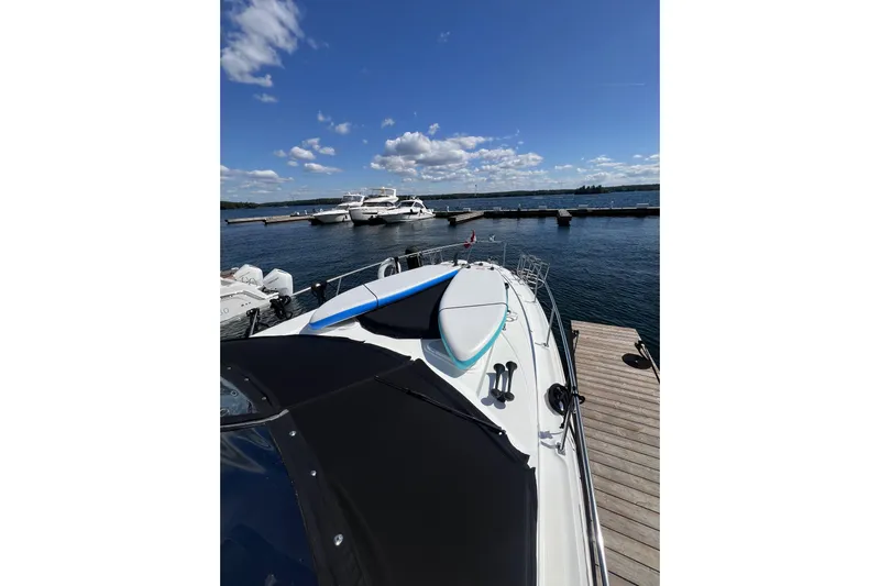  Yacht Photos Pics 2010 Cruisers Yachts 360 Express docked, with paddleboards on deck under a clear blue sky.