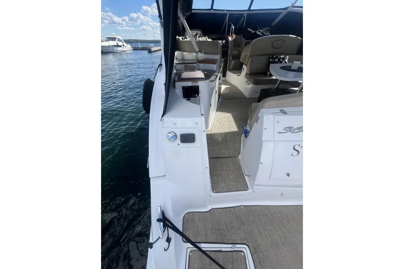  Yacht Photos Pics 2010 Cruisers Yachts 360 Express docked, showcasing interior seating and open deck.