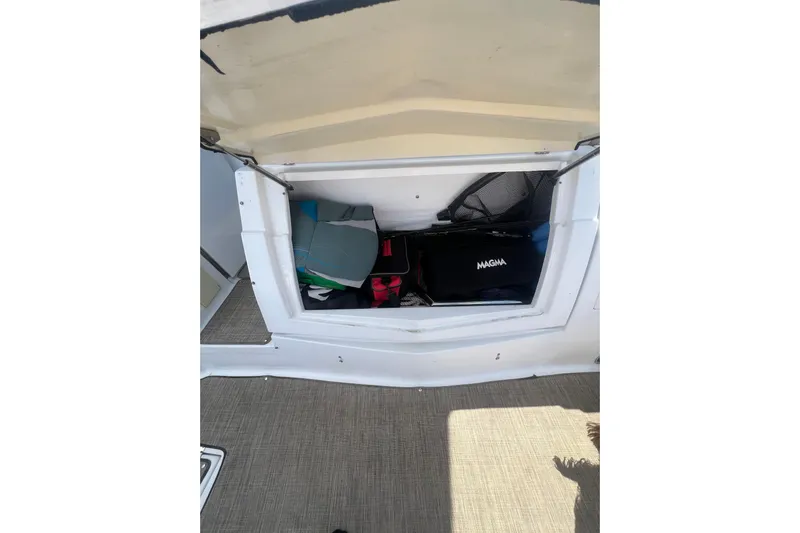  Yacht Photos Pics Storage compartment on 2010 Cruisers Yachts 360 Express, containing various boating gear.