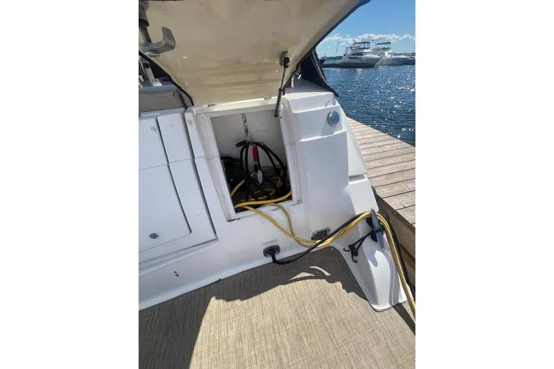  Yacht Photos Pics 2010 Cruisers Yachts 360 Express docked, showing open storage compartment with cables.