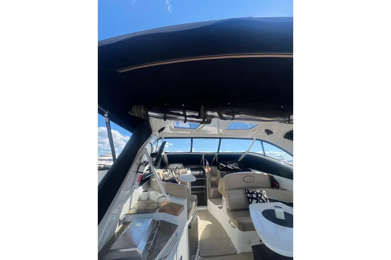  Yacht Photos Pics 2010 Cruisers Yachts 360 Express interior with seating and helm under a canopy.