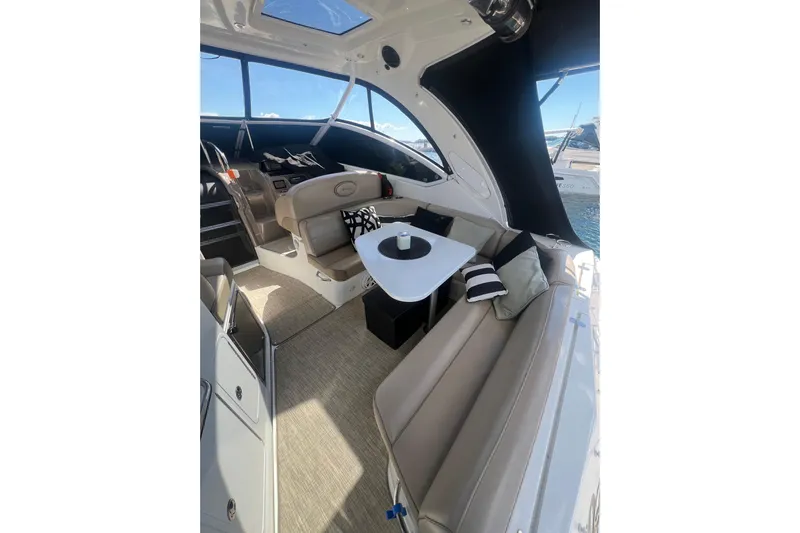  Yacht Photos Pics 2010 Cruisers Yachts 360 Express interior with seating and table, featuring modern design.