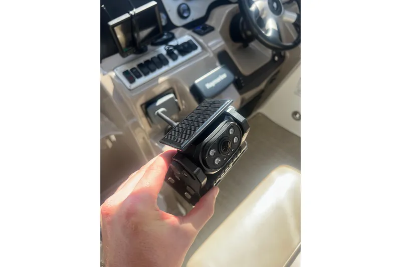  Yacht Photos Pics Hand holding a camera device inside a 2010 Cruisers Yachts 360 Express cockpit.