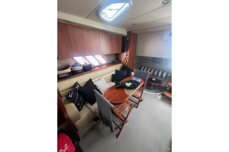  Yacht Photos Pics Interior of 2010 Cruisers Yachts 360 Express with cozy seating and wooden table.