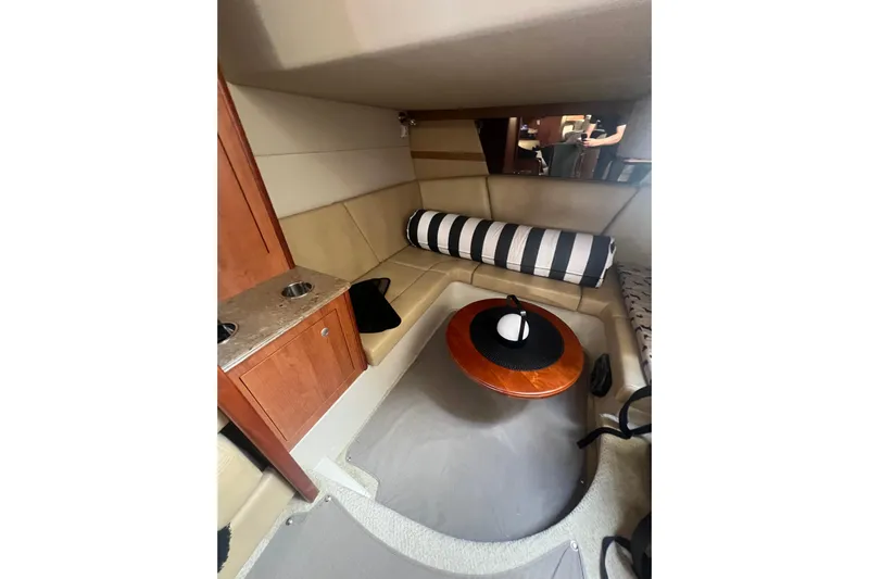  Yacht Photos Pics Interior of 2010 Cruisers Yachts 360 Express with cozy seating and wooden table.