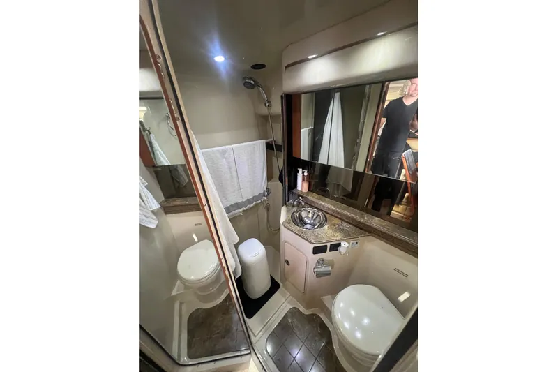  Yacht Photos Pics Bathroom interior of 2010 Cruisers Yachts 360 Express, featuring shower, sink, and toilet.