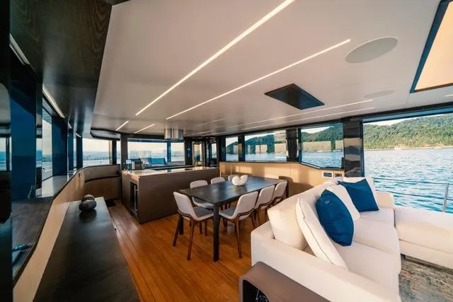  Yacht Photos Pics Luxurious interior of 2020 OKEAN 80 yacht with modern dining and seating area.