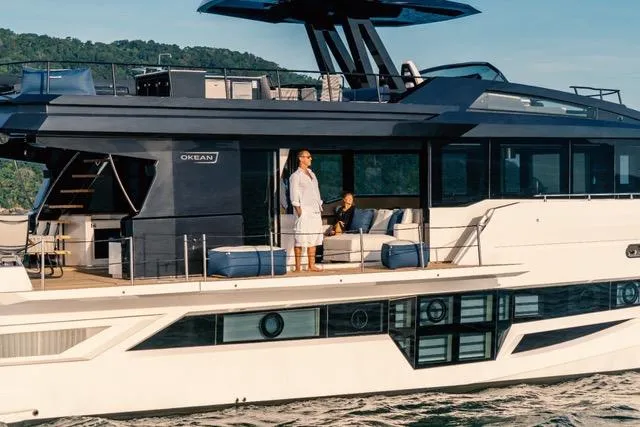 Yacht Photos Pics Luxury OKEAN 80 yacht cruising with passengers, 2020 model, scenic backdrop.