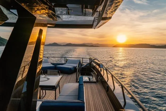 Yacht Photos Pics Luxurious 2020 OKEAN 80 yacht deck at sunset, overlooking serene ocean views.