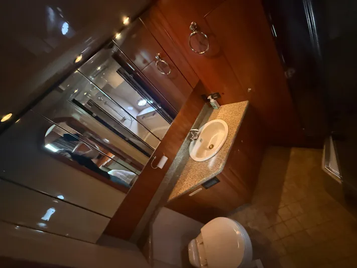  Yacht Photos Pics Luxurious bathroom in 2004 Cruisers Yachts 455 Express Motor Yacht, featuring wood cabinetry and modern fixtures.