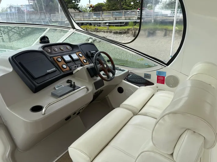  Yacht Photos Pics 2004 Cruisers Yachts 455 Express Motor Yacht helm with leather seating and navigation controls.