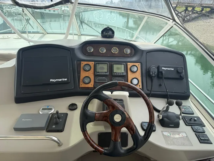  Yacht Photos Pics 2004 Cruisers Yachts 455 Express Motor Yacht helm with Raymarine navigation equipment.