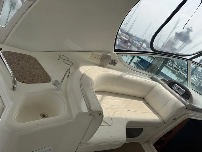  Yacht Photos Pics 2004 Cruisers Yachts 455 Express Motor Yacht interior with white seating and marina view.