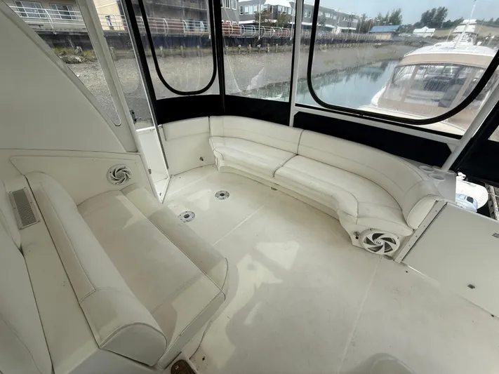  Yacht Photos Pics 2004 Cruisers Yachts 455 Express Motor Yacht interior with white seating and large windows.