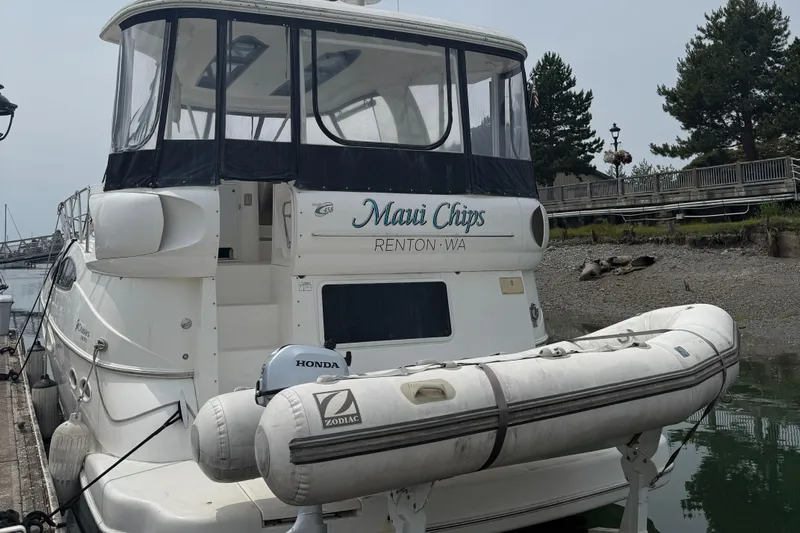  Yacht Photos Pics 2004 Cruisers Yachts 455 Express Motor Yacht docked with inflatable boat.